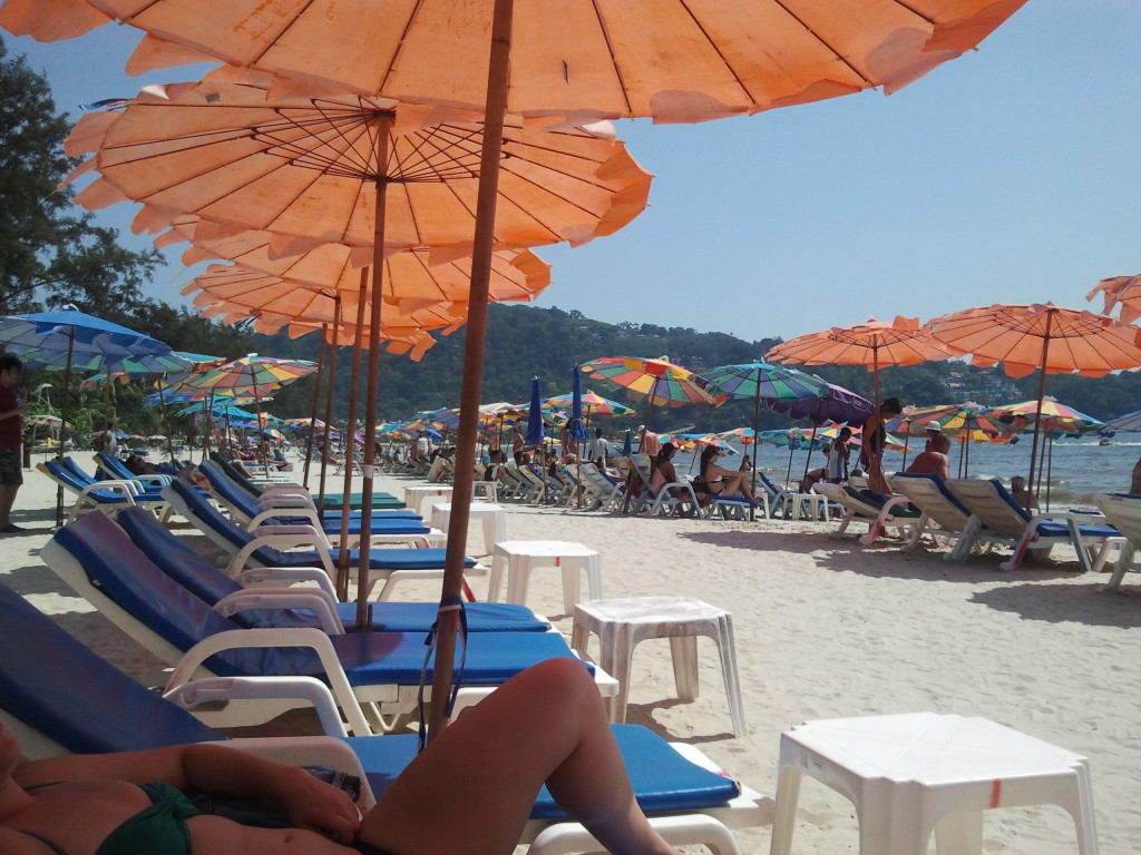 Patong Beach. Phuket Thailand. Umbrella beach chairs. 