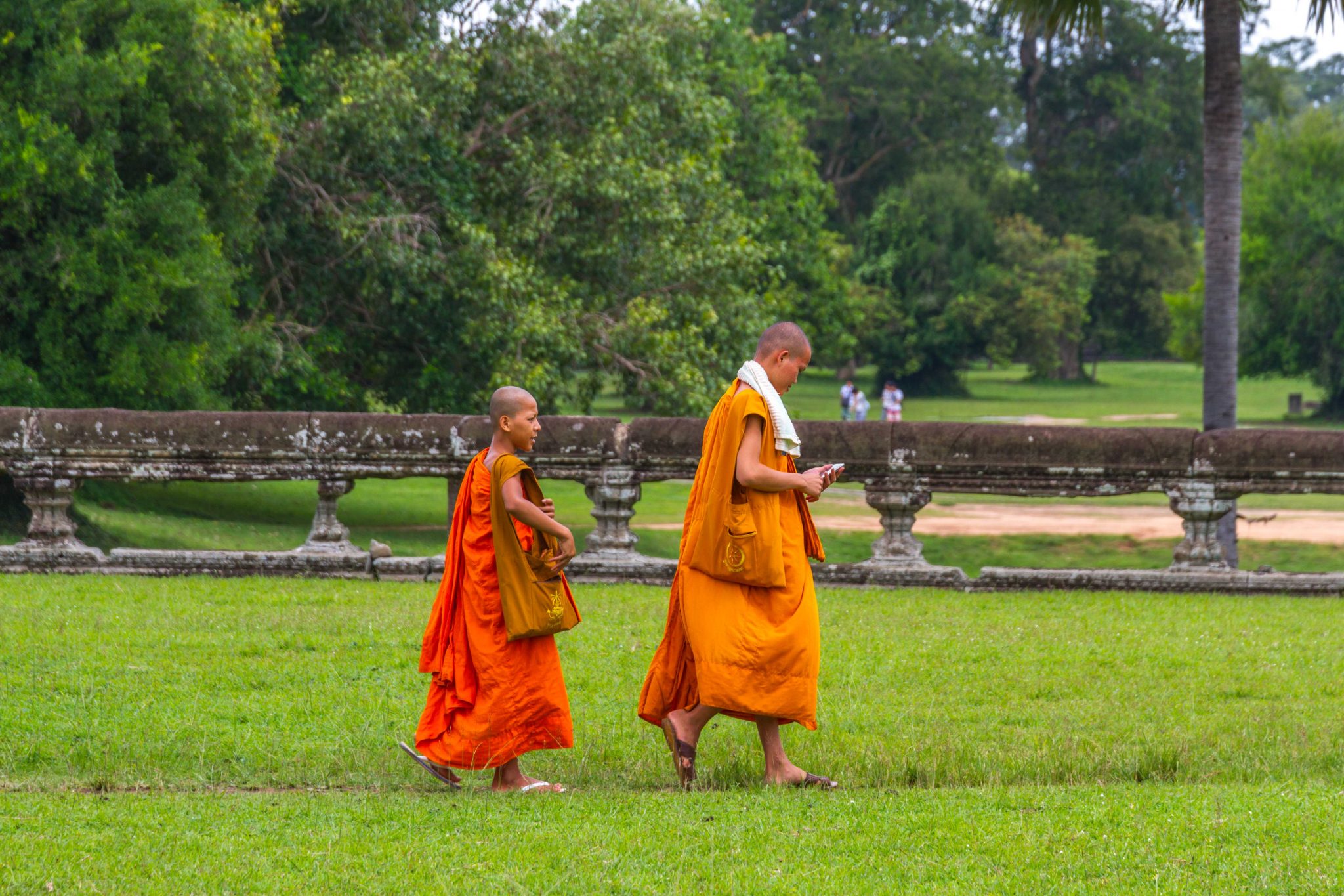 Young Monks at Angkor Wat Temple Complex with Smartphone